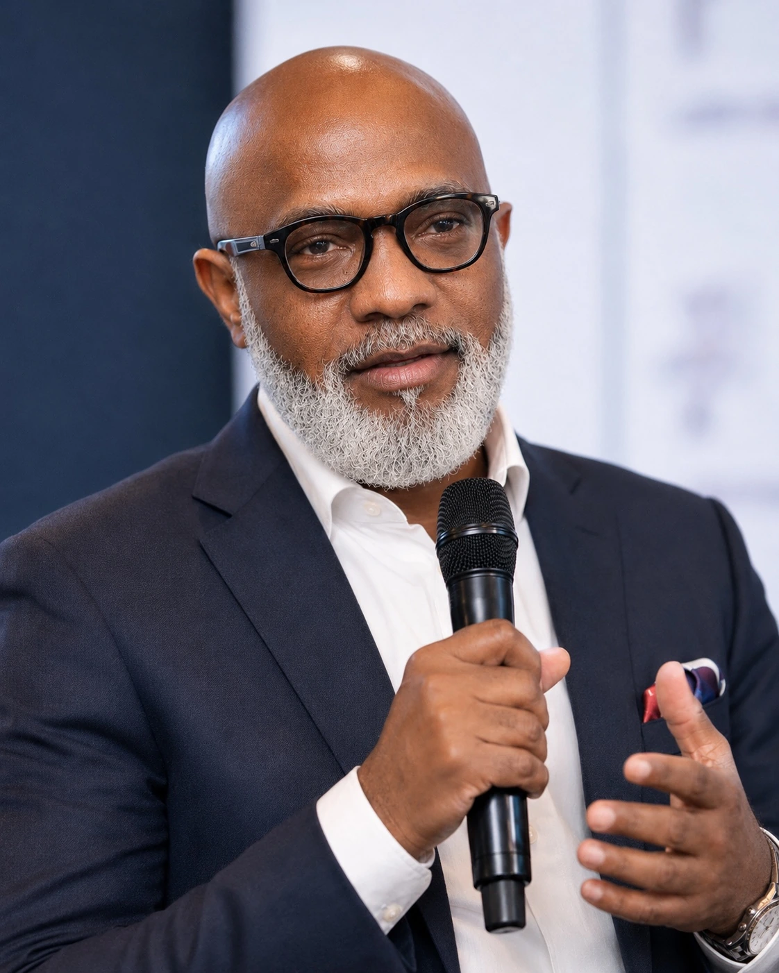Onosoji O. Ononuga speaking to an audience with a microphone.